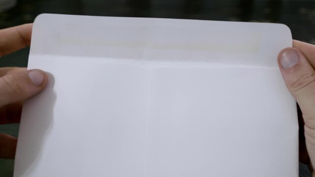 Closing an envelope, mail letter being closed up. Glue folding mail package, an envelope