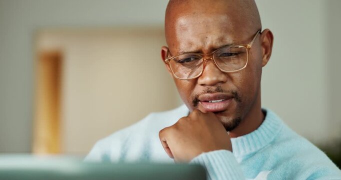 Confused, laptop and black man in home with remote work for mistake on coding project with thinking. Plan, computer and software engineer with research on website development with glitch in house.