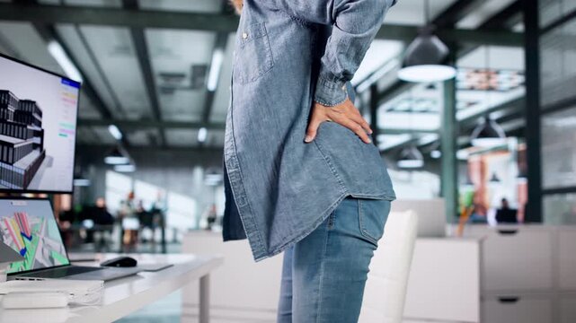 Older Woman Experiencing Back Pain While Using Computer