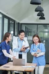 Fototapeta premium Medical Team Happily Collaborating and Recording Patient Data in Office