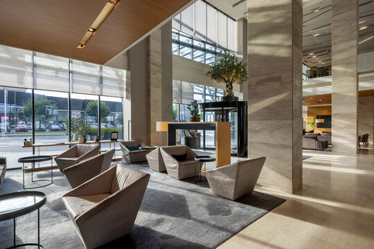 Luxury hotel lobby interior with modern armchairs and big glass windows