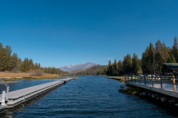 Fototapeta premium Twin Boat Docks on Hume Lake with Snowy Sierra Nevada Mountain Backdrop California
