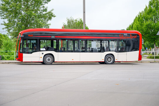 Iserlohn, Germany - June 05, 2026: MVG public transport bus parked roadside with green trees