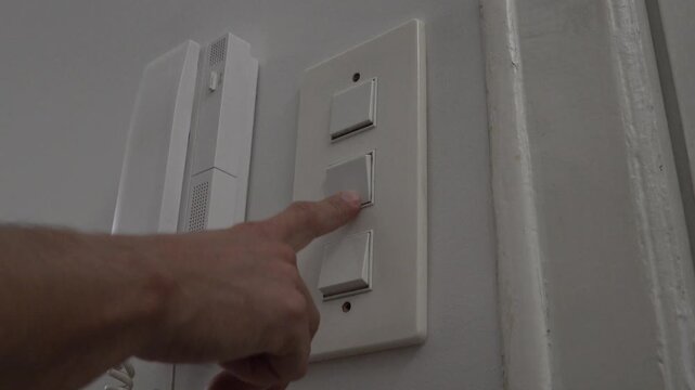 opening and closing the hallway light switches. High quality 4k footage