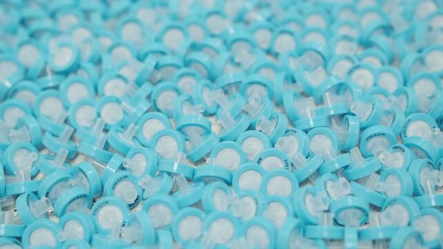 Macro laboratory footage of PTFE syringe filters used for sample preparation before liquid chromatography and HPLC analysis. Analytical chemistry lab process, filtration of samples, research