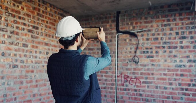 Photography, inspection and man with tablet at construction site, compliance or infrastructure review. Back, evaluation and person with tech screen for wiring, installation or electrical line picture