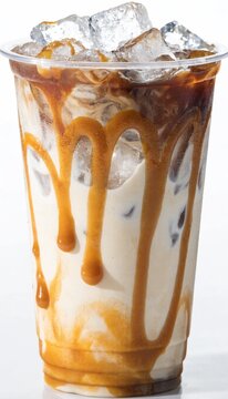 delicious iced caramel macchiato is served in a clear plastic takeaway cup filled with crunchy ice cubes, beautifully showcasing a rich espresso layer at the top and a sweet golden caramel sauce drizz