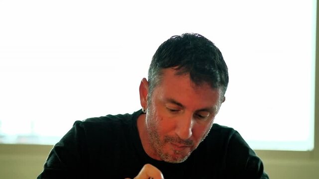 A man eats a type of Italian pasta called "penne". The man is forty-two years old and of Caucasian origin