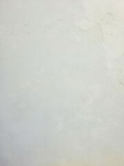 Fototapeta premium White plaster wall texture background. Rough stucco surface with subtle unevenness and copy space. Minimalist concrete backdrop.