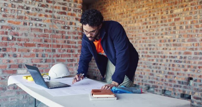 Typing, laptop and man with blueprint at construction site, planning update and change for renovation. Engineering, remodeling or architect writing for schematic revision, pc or property development