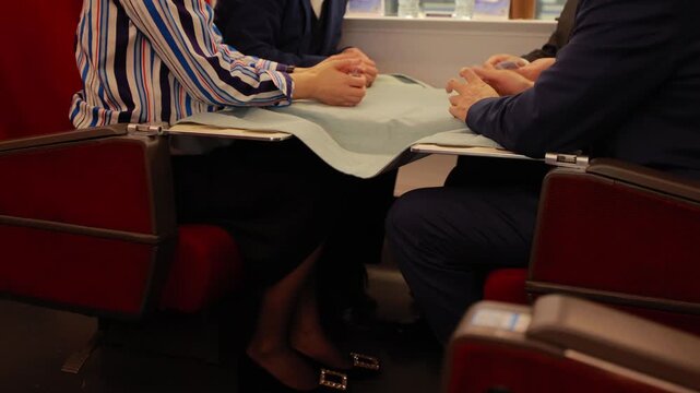 Two People Having a Conversation at a Table in a Train Carriage