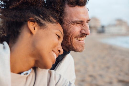 Happy couple spending leisure time at beach