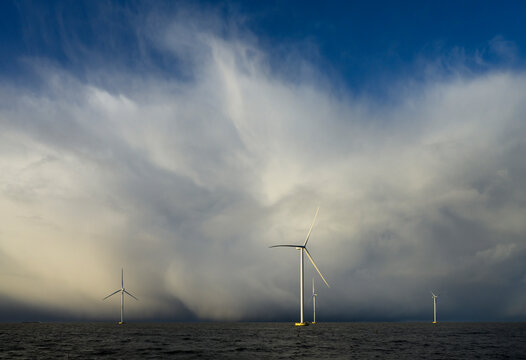 Netherlands, Flevoland, Lelystad, Thick clouds over offshore wind farm in IJsselmeer