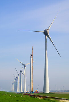 Row of wind turbines undergoing maintenance in Noordoostpolder