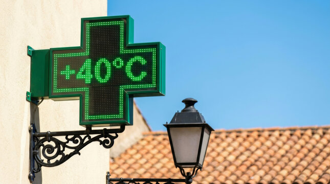 Urban heat wave city hot pharmacy sign glows near street lamp under summer sun. Warming crisis climate change. cooling temperature, sun climate weather, sunlight summer
