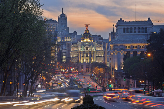 Madrid, View of Calle de Alcala and Plaza de Cibeles, Edificio Metropolis blurred traffic at dusk