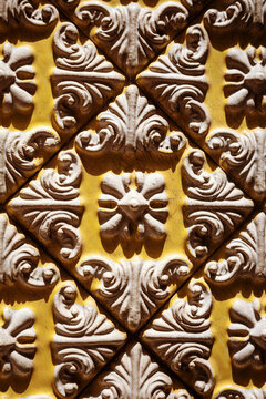 Yellow artisanal ceramic tile with relief pattern in Portugal