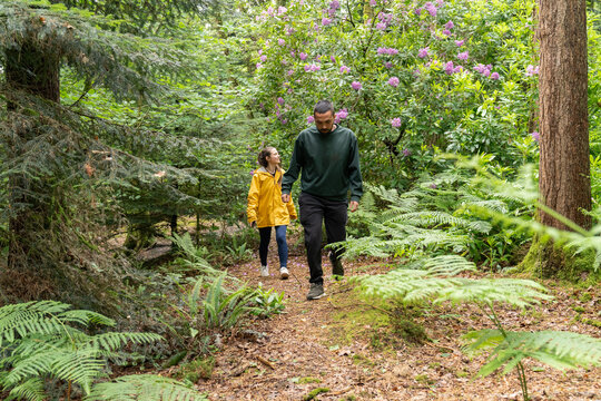 Couple enjoying adventure hiking in green forest trail