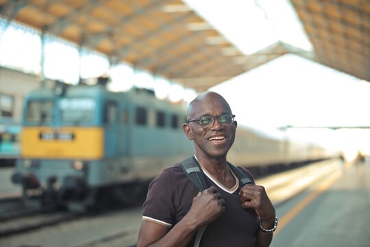 Happy mature traveler smiling at the train station