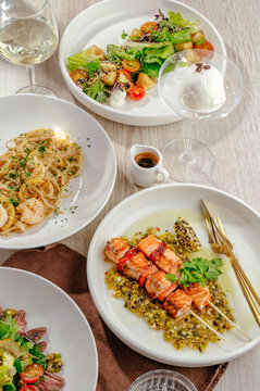 Gourmet lunch spread with salmon pasta and salad