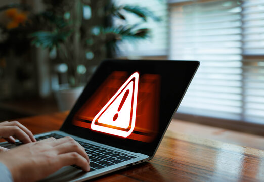 Laptop displaying critical cybersecurity warning alert, online threat detection, malware attack risk, data breach protection, network security monitoring and digital safety technology concept.