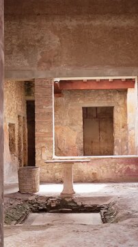 Ancient roman atrium house inside Pompeii ruins, Vertical shot tilting down
