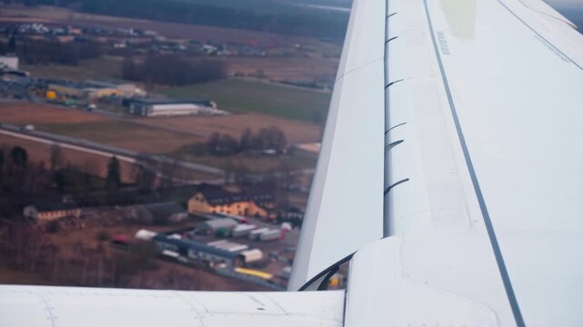 Extended leading edge slats on the right wing of an aircraft preparing for landing, handheld