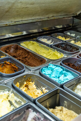 Fototapeta premium Displaying a variety of colorful gelato flavors in a shop