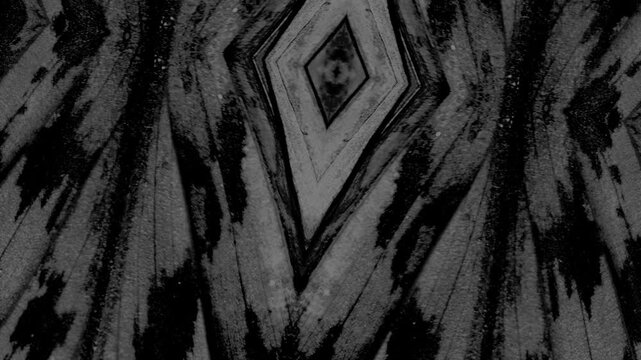 Abstract geometric monochrome pattern featuring diamond symmetry, layered textures, flowing streaks, and contrast.