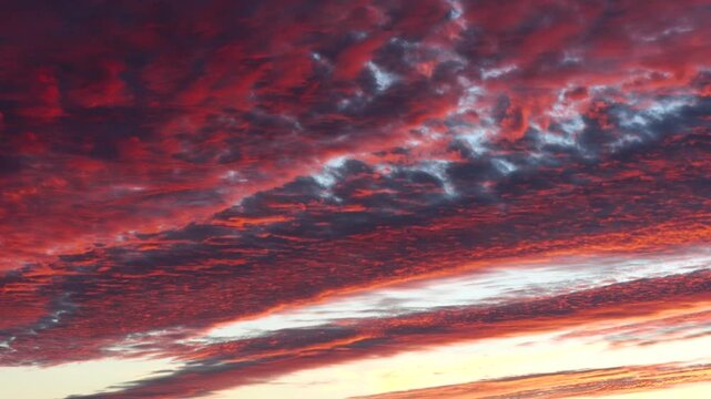 4K time lapse footage of orange clouds moving and turning into dark in sunset, close up view of beautiful cloudscape in nature, b roll shot.