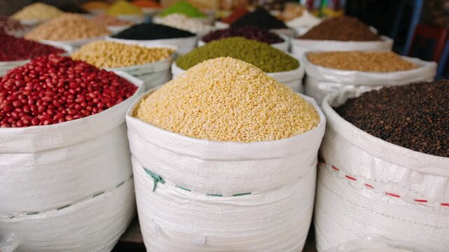 Colorful assortment of beans, grains, and spices for sale at a traditional street market in vietnam