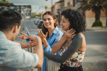 Diverse friends talking and laughing communicating in sign language © Miljan Živković