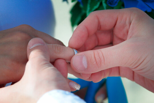 hands of the person getting married with rings