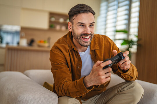 Man enjoying video game playing on couch