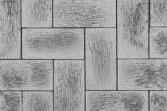 Grey concrete paving slabs background with textured grooved surface