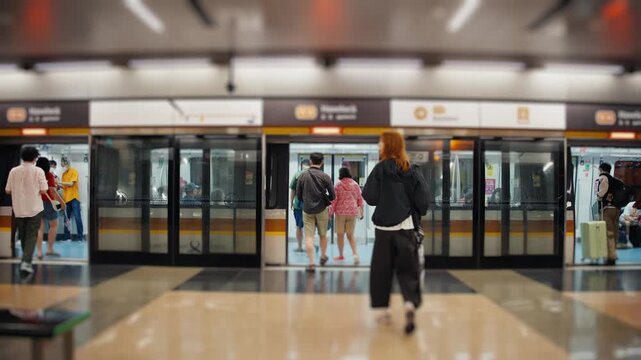 Unrecognizable people walking towards a modern subway train