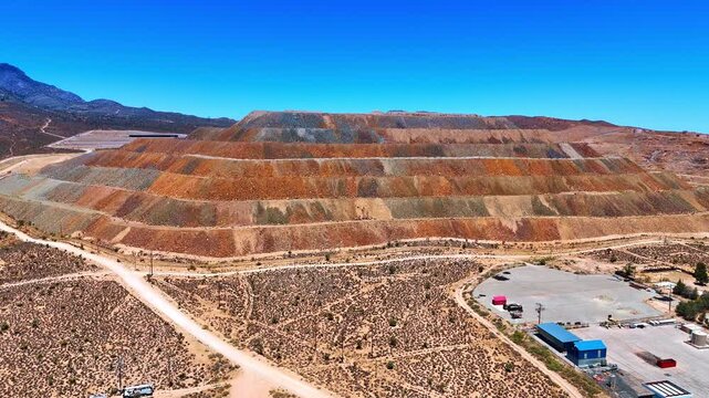 Moving around the terraced mine in the hot deserted area. Copper, gold, or rare-earth mining operation in the USA.
