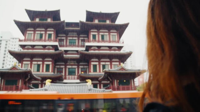 Female tourist photographing buddha tooth relic temple in singapore