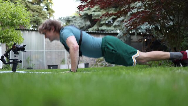 Videographer performs classic push ups during outdoor training preparing the body for heavy camera work Long filming days require strength endurance and resilience
