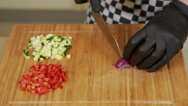 Chef chopping vegetables on a cutting board