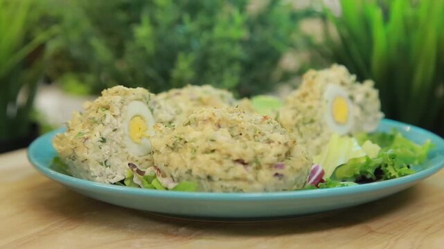 Baked fish muffins plated and served on a dish with fresh lettuce leaves