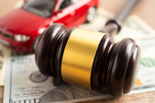 Hammer gavel judge and Euro banknote money with car vehicle accident, insurance coverage claim lawsuit court case.