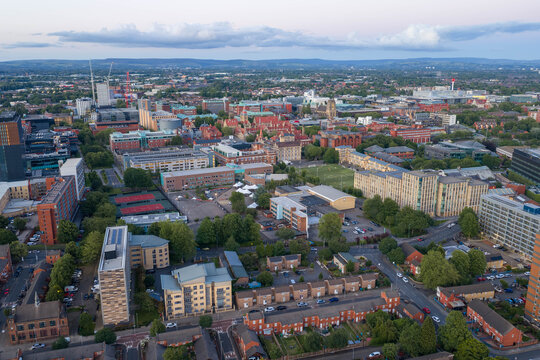 Aerial image of Manchester at sunset, showcasing residential housing estates, university campus developments