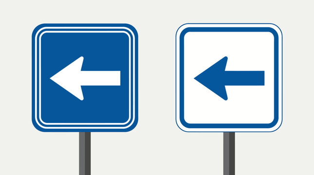 Two blue left-turn traffic signs on poles, urban road signage guiding drivers to turn left