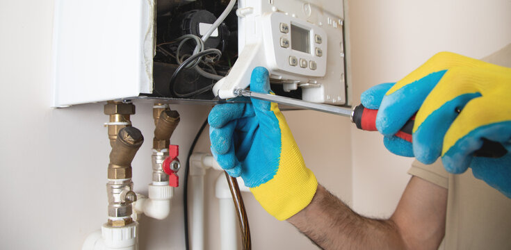 Master repairs a heating system in apartment.