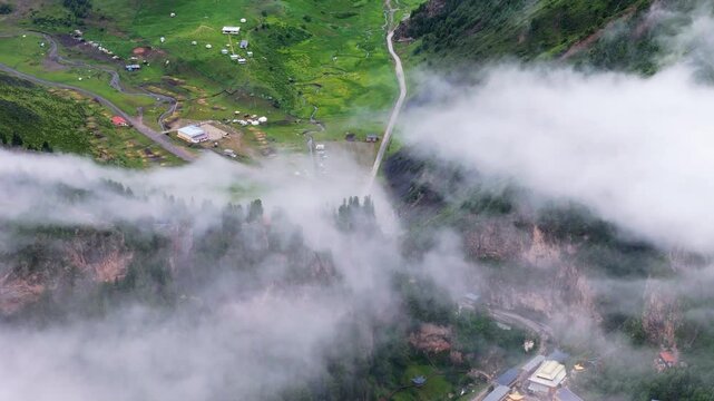 Aerial Drone View of Fog-Covered Mountain Village in Gannan, Gansu, China