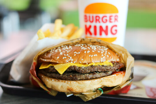 Jakarta, Indonesia - May 23, 2026: Closeup of a Burger King packet meal set featuring a double cheeseburger, french fries, and a drink.