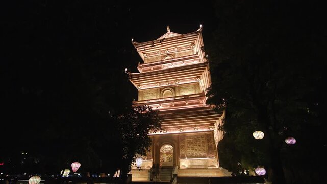 Ancient buddhist temple glowing with warm lights in Hoa Lu, Vietnam