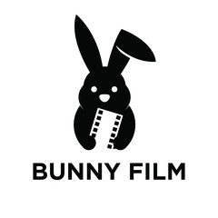 Fototapeta premium Minimalist Black Bunny Film logo featuring a rabbit silhouette holding a movie film strip, ideal for entertainment and video production branding.