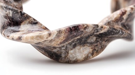 Obraz premium Macro shot of a polished natural marble stone twist ornament on a bright white background for luxury interior design concepts